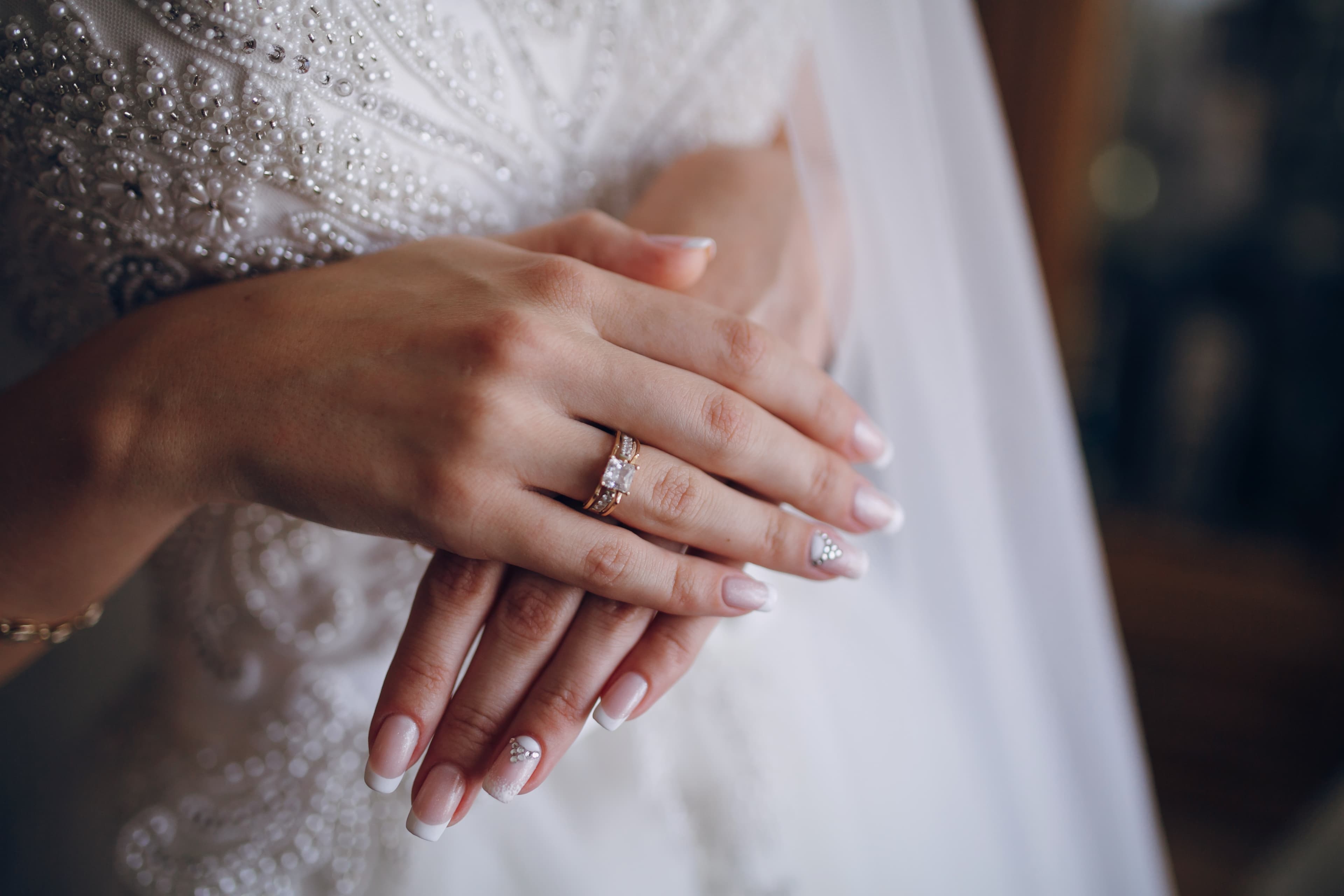 A bride's hands with an engagement ring